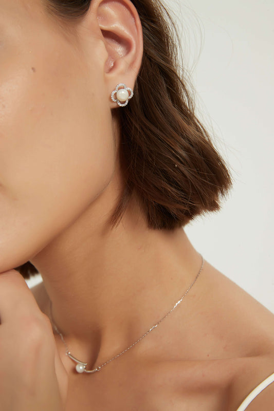 Eleanor earrings featuring white cubic zirconia and freshwater pearls, crafted in 14k yellow gold plated material.