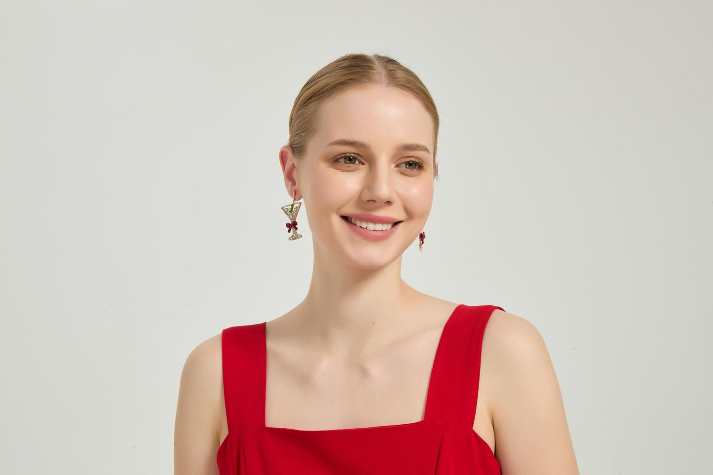 Martini earrings showcased on a model, adding a playful and stylish touch to her outfit.